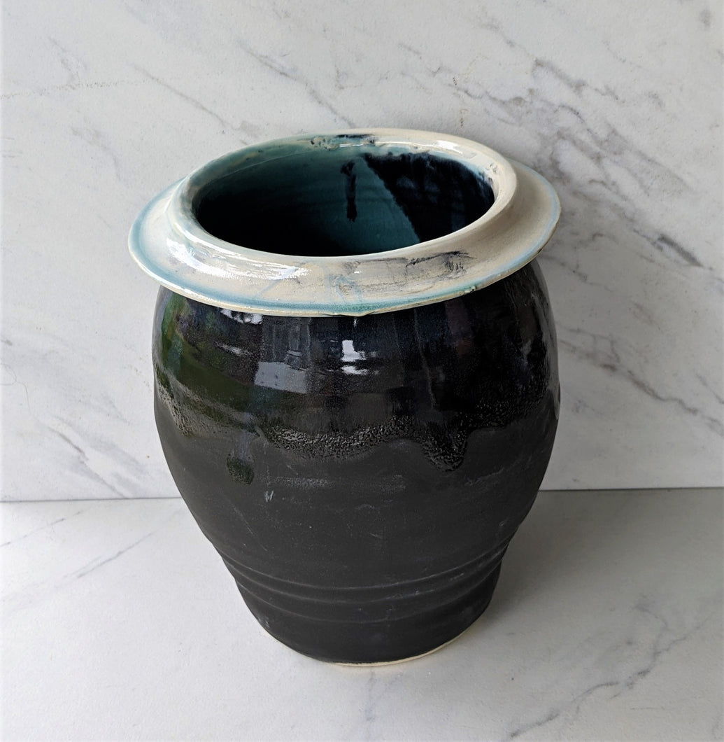 Black wide pot with white flared lip and robin's egg and black inside