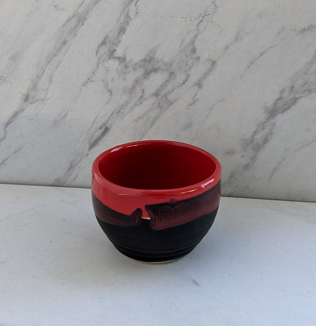 6oz small bowl with matte black and red glaze dripping down rim