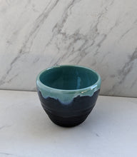 Load image into Gallery viewer, Small 8oz bowl of matte black base with robin&#39;s egg blue dripping over lip.
