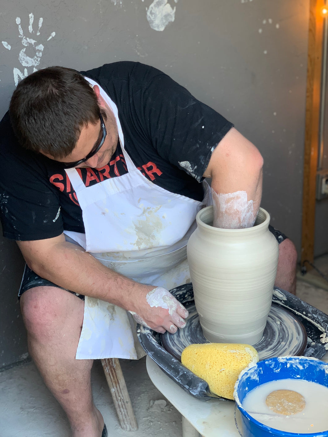 Deaf Blind Potter throwing on the potter wheel